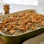 Green bean casserole from scratch with creamy mushroom sauce and crispy fried onions on top