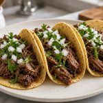 Beef tacos in corn tortillas with onion and cilantro