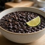 Bowl of black bean soup with lime