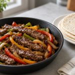 Steak fajitas with peppers in a skillet